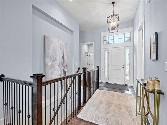 Foyer featuring dark hardwood / wood-style floors and an inviting chandelier